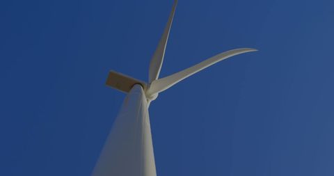 Low Angle View of Modern Wind Turbine Against Clear Blue Sky