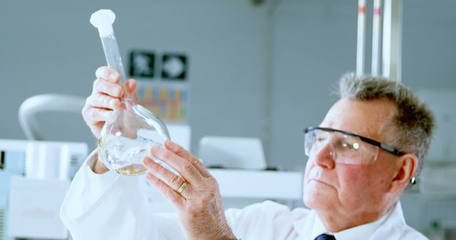 Senior Scientist Examining Chemical Solution in Modern Laboratory - Download Free Stock Images Pikwizard.com