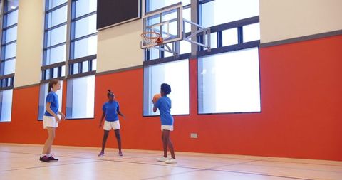 Diverse Children Playing Basketball in School Gym