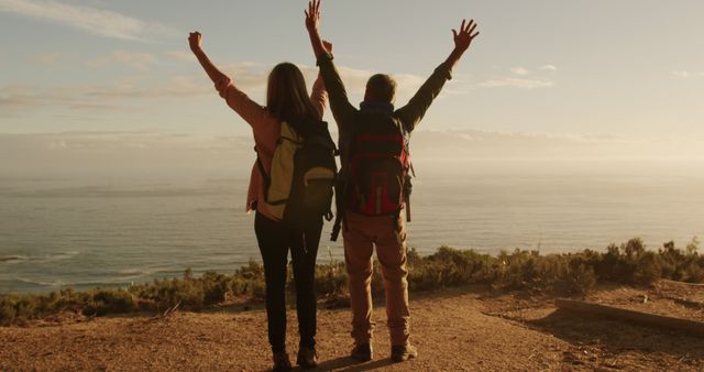 Happy Hikers Celebrating Success with Breathtaking Ocean View - Download Free Stock Images Pikwizard.com