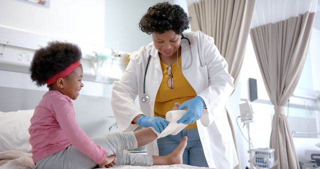 Doctor Treating Child's Leg Injury in Hospital Room - Download Free Stock Images Pikwizard.com