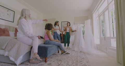 Bridal Fitting with Friends in Warm, Bright Bedroom