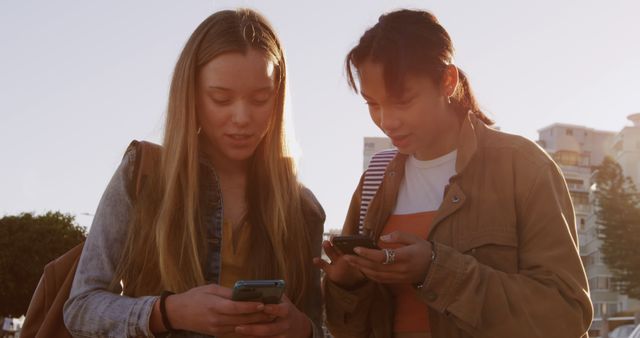 Teen Girls Bonding Outdoors Using Smartphones - Download Free Stock Images Pikwizard.com