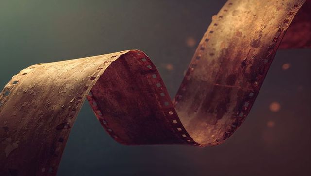 Rusty film strip twisting with particles and bokeh lighting