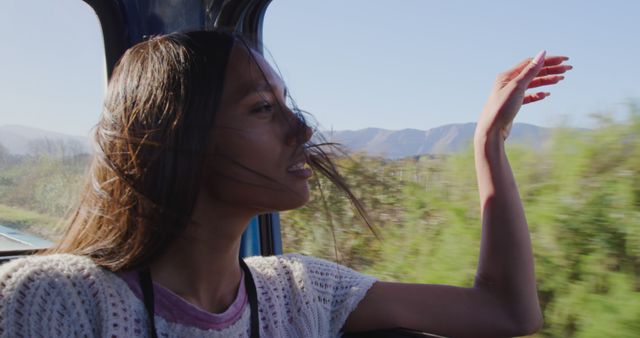 Woman Enjoys Scenic View from Moving Vehicle on Sunny Day - Download Free Stock Images Pikwizard.com