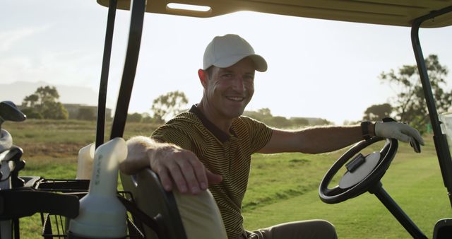 Smiling golfer resting in a golf cart during a game on a sunny day, promoting leisure activities and enjoyment of sports. Perfect for use in advertisements for golf courses, sport equipment, outdoor leisure experiences, and health and wellness campaigns emphasizing relaxation and recreation.