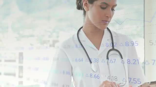 Biracial female doctor examines patient records on a tablet with a data processing overlay background. Suited for healthcare and medical technology concepts, illustrating the integration of data in modern medicine, telehealth services, or innovative medical practices.