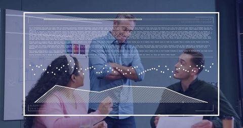 Coworkers reviewing holographic data overlay in meeting room collaborating on documents