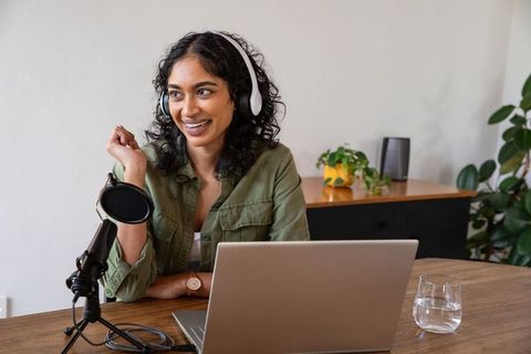 Indian Woman Podcasting from Home Office with Laptop and Microphone