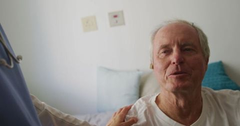 Senior man assisted by nurse with hearing aid