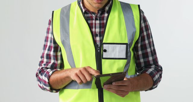 Construction Worker in Safety Vest Using Tablet for Inspection - Download Free Stock Images Pikwizard.com