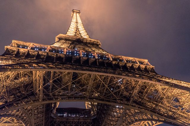 Unique low-angle view of illuminated Eiffel Tower at dusk - Download Free Stock Photos Pikwizard.com