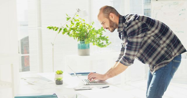 Man Working on Laptop in Bright Modern Office - Download Free Stock Images Pikwizard.com