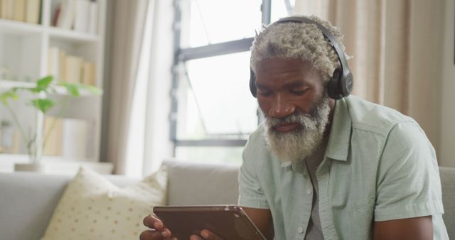 Elderly Man with Headphones Relaxing at Home - Download Free Stock Images Pikwizard.com
