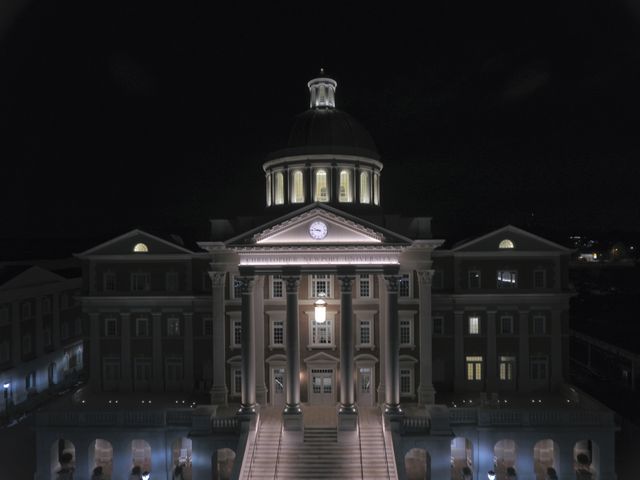 This image showcases a historic building with an illuminated dome and grand staircase, shot at night. The building features classical architectural design with columns, a clock, and well-lit windows and exterior. Ideal for use in content related to heritage architecture, government buildings, nighttime photography, and classical design. Suitable for websites, brochures, educational materials, and historical fiction covers.