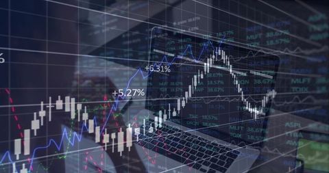 Laptop Displaying Trading Charts and Data Analysis in Modern Workspace