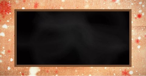 Empty Blackboard Against Orange Snowflake Background
