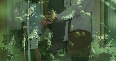 Doctor and patient shaking hands through transparent partition with virus overlay