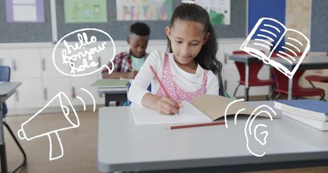 Young student writing at classroom desk with language doodles and focused learning