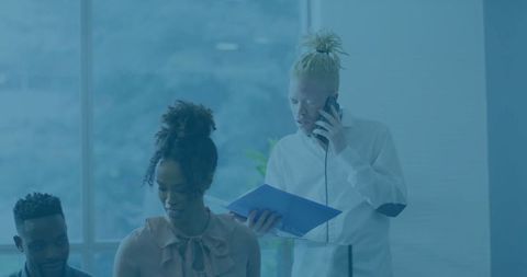 Coworkers Collaborating Over Documents in Modern Office