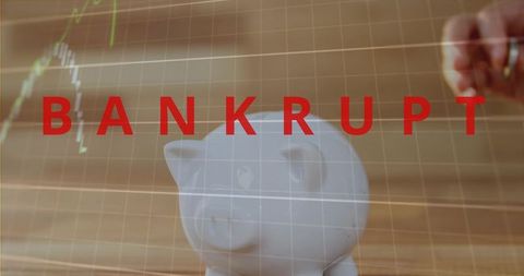Holding hand placing coin into piggy bank with red bankrupt overlay and falling chart