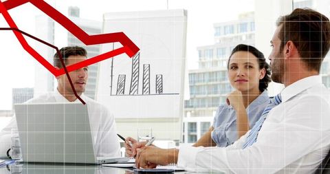 Corporate Team Analyzing Downward Red Trend Line During Boardroom Strategy Meeting