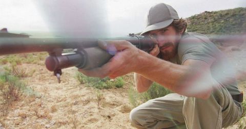 Sharpshooter Man Aiming Rifle in Desert Wilderness