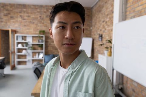 Confident Professional Working in Open Office Environment