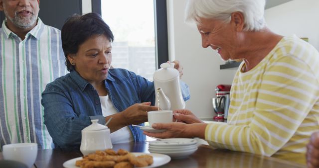 Happy senior diverse people drinking tea at retirement home - Download Free Stock Photos Pikwizard.com