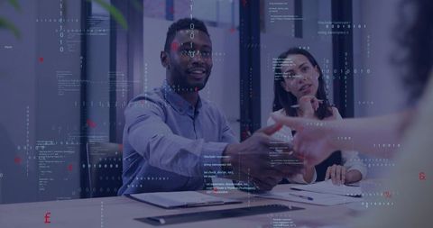 Team members shaking hands across modern conference table with digital code overlay