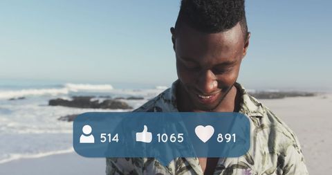 Man Engaging with Social Media on Beach with Icon Overlays