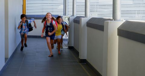 Joyful Schoolchildren Running in Sunny School Corridor - Download Free Stock Images Pikwizard.com
