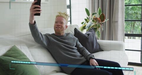 Man Taking Selfie with Digital Interface Overlay in Modern Living Room