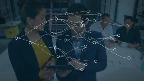 Professionals in an office setting are interacting with virtual reality wearables, represented with network lines overlay, signifying digital connectivity and interactive business solutions. This can be used for articles on modern workplace technologies, digital collaboration, or innovative business practices.