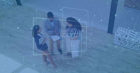 Business team reviewing data with digital network overlay overhead view for collaboration