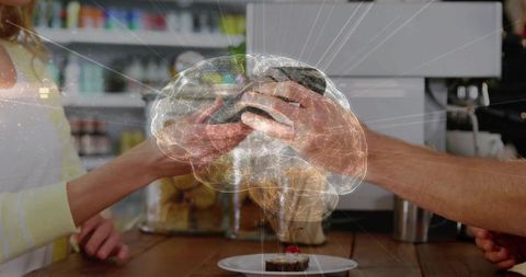 Handing contactless terminal at cafe counter with holographic brain overlay