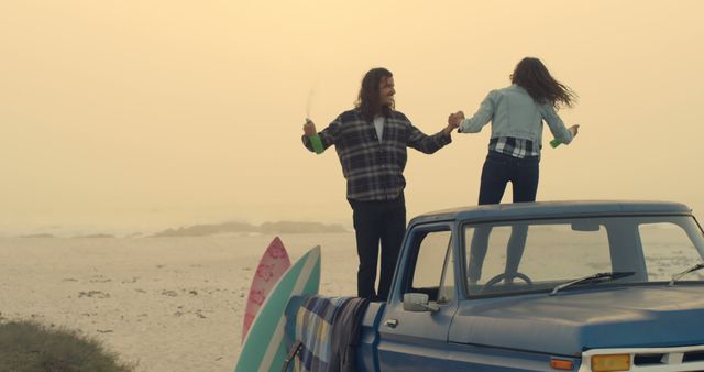 Couple standing on vintage truck, enjoying peaceful beach sunset. Surfboards leaning, hinting at day of surfing. Youthful, joyful moment perfect for lifestyle, travel, adventure, or romantic themes.