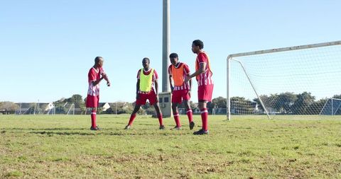 Youth soccer team preparing for match on sunny field