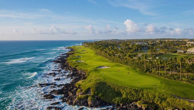 Cliffside golf course with palm fairways, greens, bunkers and sweeping ocean views