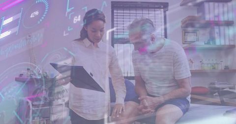 Clinician examining senior patient knee with tablet and holographic health data overlay