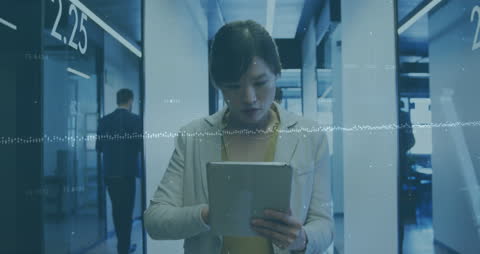 Businesswoman Analyzing Financial Data on Tablet in Office Space