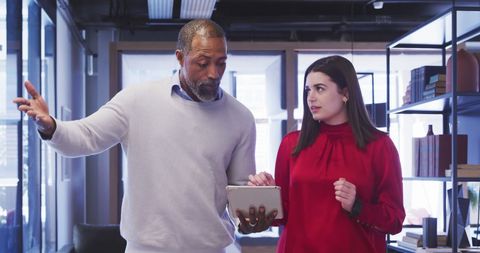 Diverse Colleagues Discuss Project in Modern Office