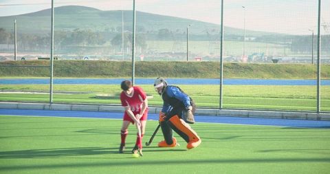 Teen Field Hockey Training with Coach on Outdoor Pitch