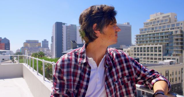 Man Relaxing on Rooftop Looking at City Skyline - Download Free Stock Images Pikwizard.com