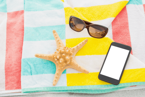 Transparent Sunglasses and Starfish on Striped Beach Towel