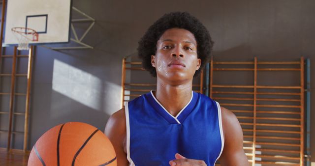 Portrait of african american male basketball player holding ball - Download Free Stock Photos Pikwizard.com