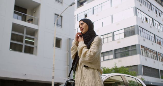 Confident Muslim Woman Talking on Smartphone in Urban Environment - Download Free Stock Images Pikwizard.com