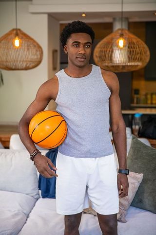 African American Athlete Relaxing at Home with Basketball