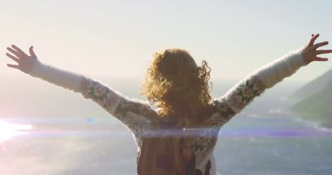 Joyful Woman Embraces New Day by the Beach