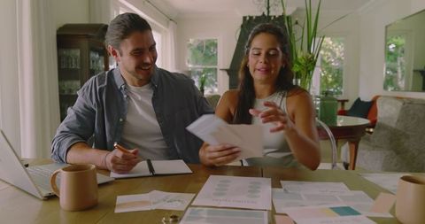 Couple Sharing Wedding Ideas at Home